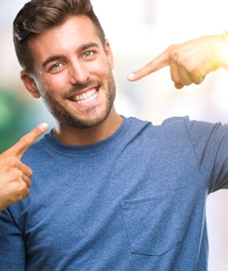 man pointing to his smile after dental bonding in Ocala, FL