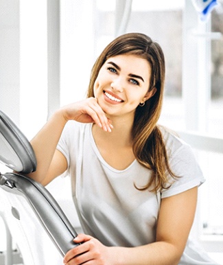 Woman with dental bridge in Ocala smiling in dental chair