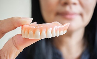 a person in Ocala holding a denture