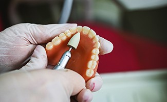 a technician working on making a denture