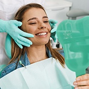 Ocala emergency dentist touching a patient’s face during an exam