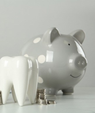 Tooth and piggy bank for cost of tooth extractions in Ocala  