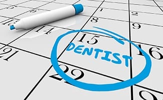 Calendar with reminded to visit Ocala implant dentist circled in blue