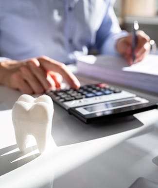 Ocala implant dentist calculating cost of dental implants in Ocala