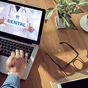 Using laptop to look up dental benefits information