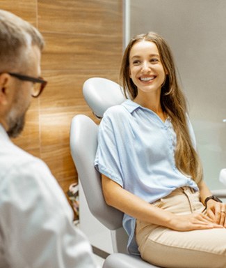 Female patient smiling at dentist at dental appointment