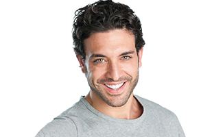 A younger man smiling after learning how to prevent dental emergencies in Ocala