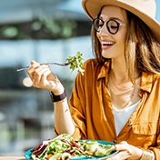 A female sitting down to eat a healthy salad in Ocala