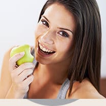 Woman eating green apple