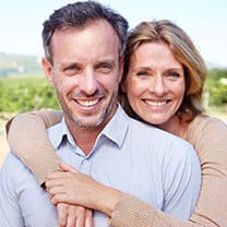 woman hugging husband around shoulders