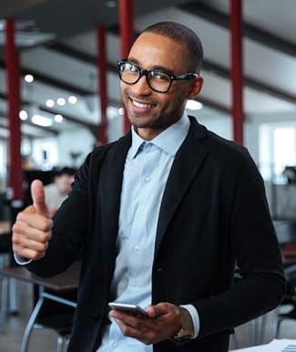 smiling person giving a thumbs-up