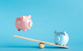 Piggy banks on balance scale