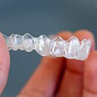 hand holding clear aligner