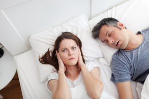 man snoring in bed