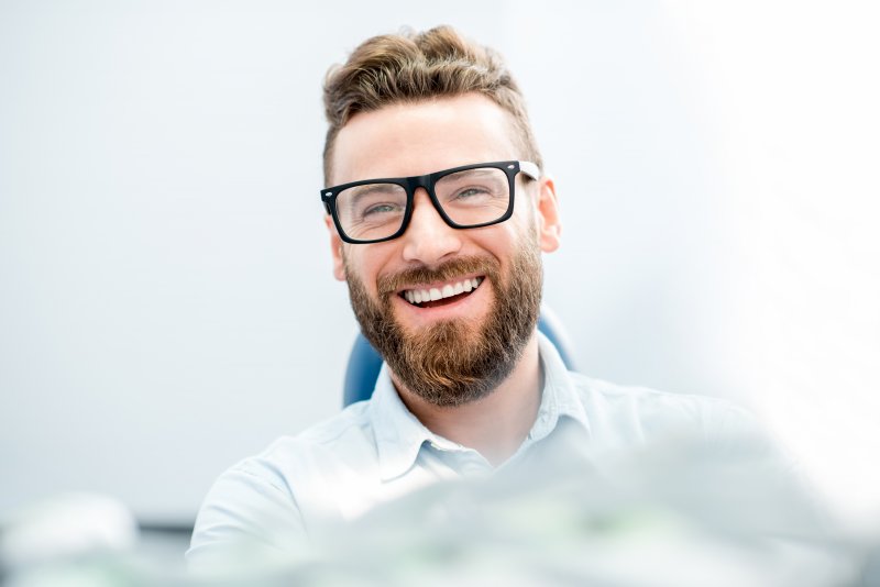 bearded man wearing glasses smiling