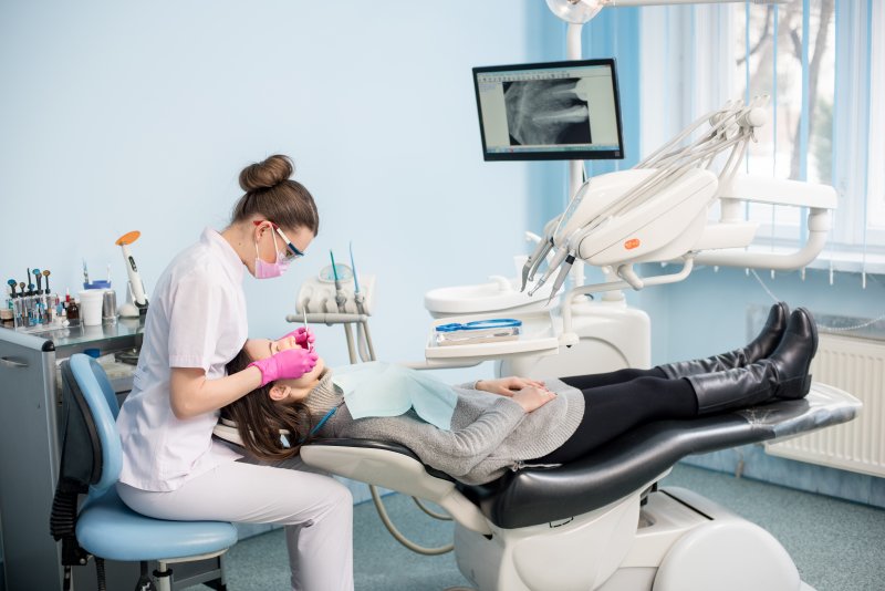 a person having their teeth checked at the dentist’s office