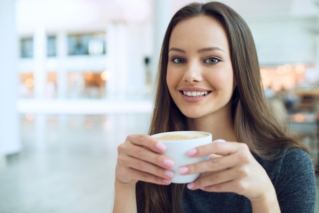 Woman drinking coffee.